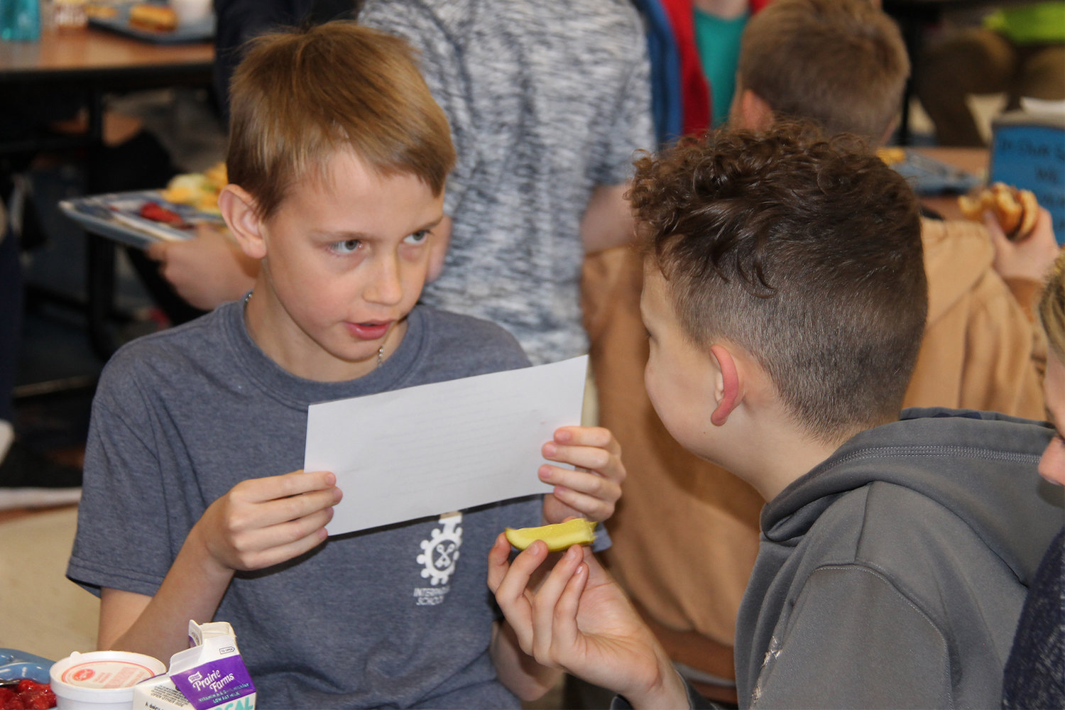 Students get serious about the ice-breaker questions at their tables.